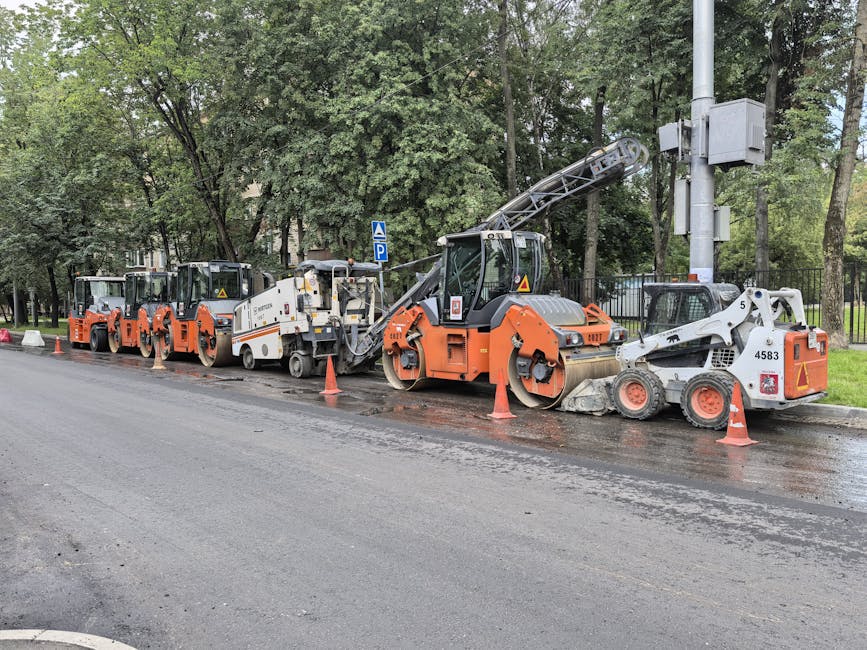 Heavy machinery lined up for road construction in a city